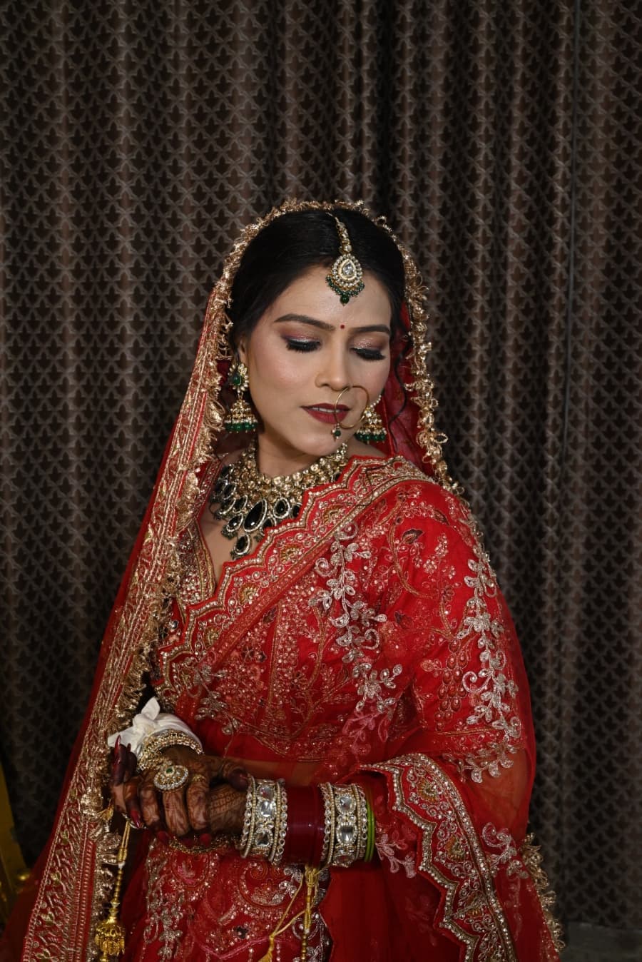 Bridal portrait with a soft gaze and layered necklaces