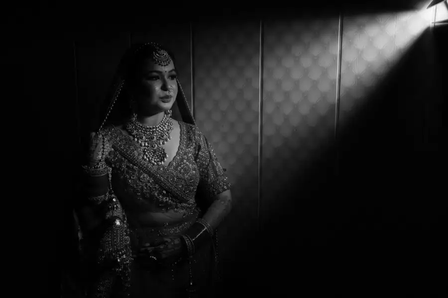 Black-and-white bridal portrait in dramatic side light