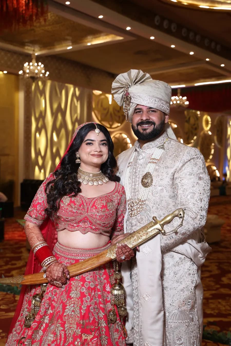 Bride and groom smiling together, sword in hand