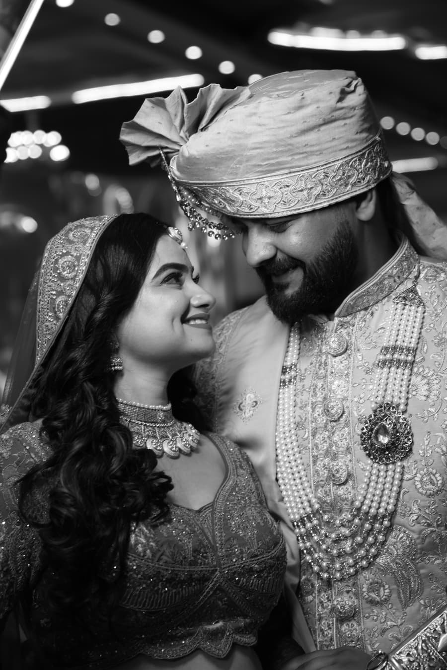 Black-and-white close-up of the couple sharing a smile