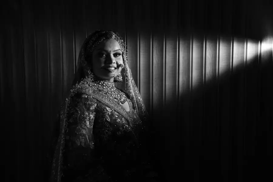 Black-and-white bridal portrait in dramatic light
