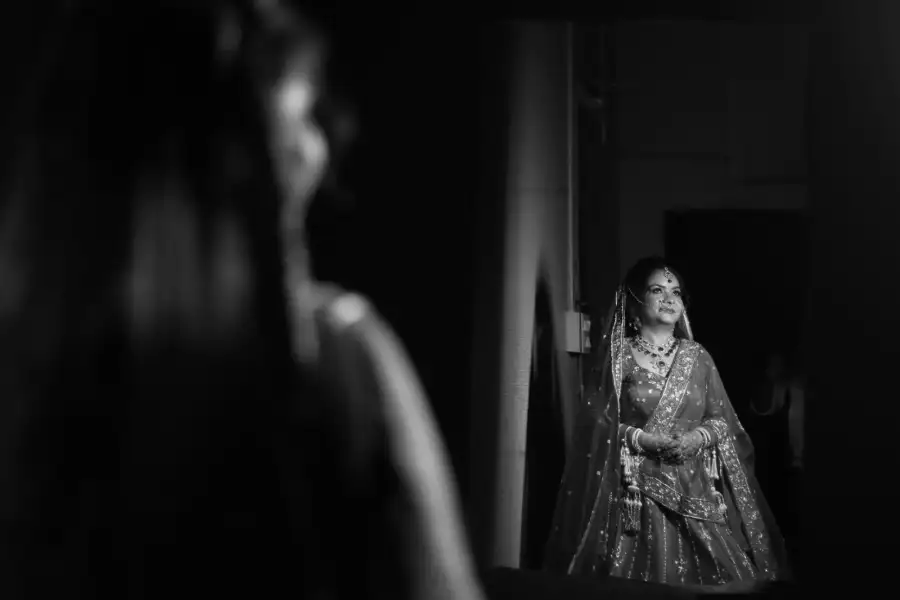 Bride glancing back through a doorway, framed by shallow depth of field